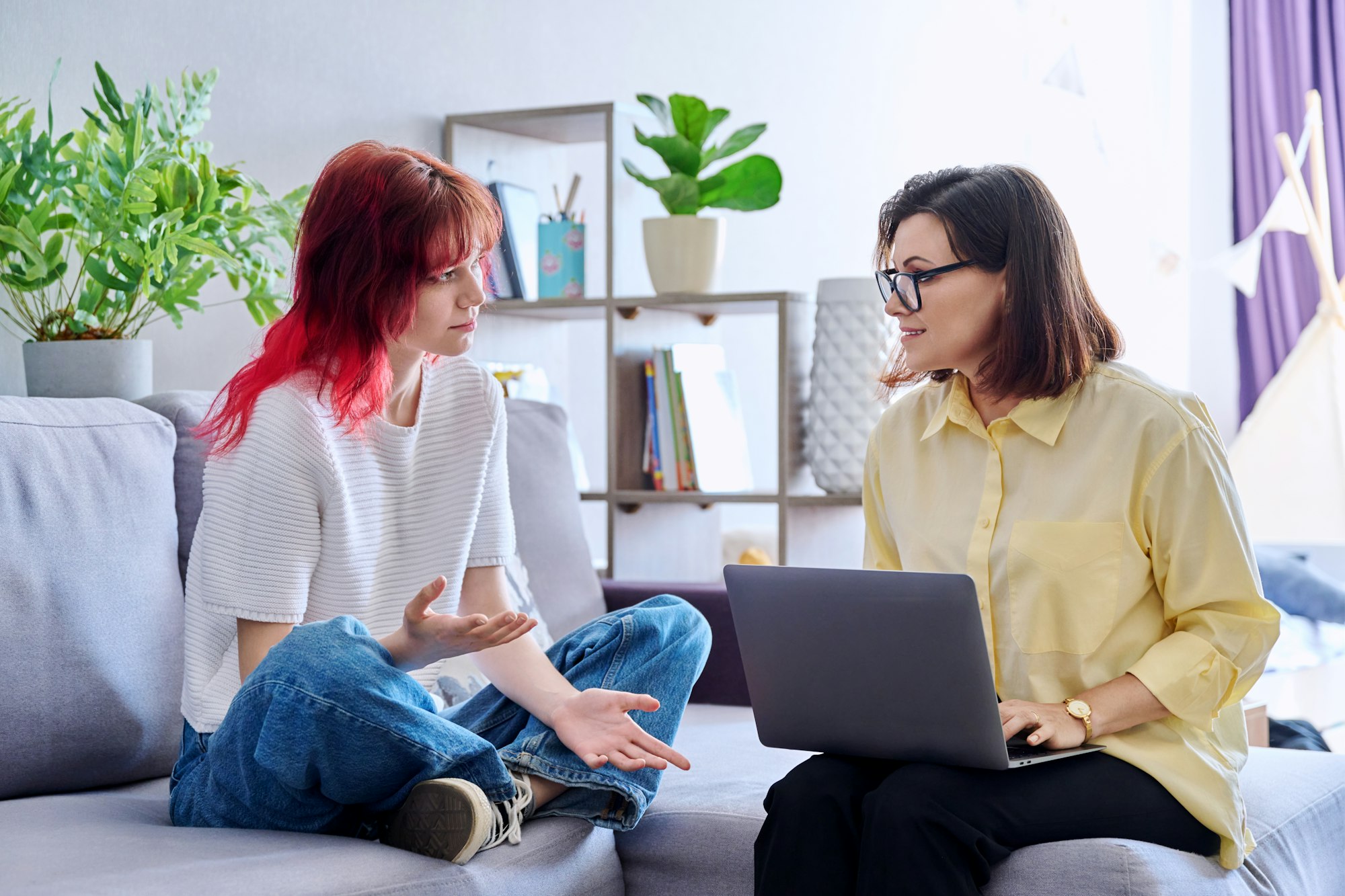 Therapy session for teenage girl, psychologist and patient together in office