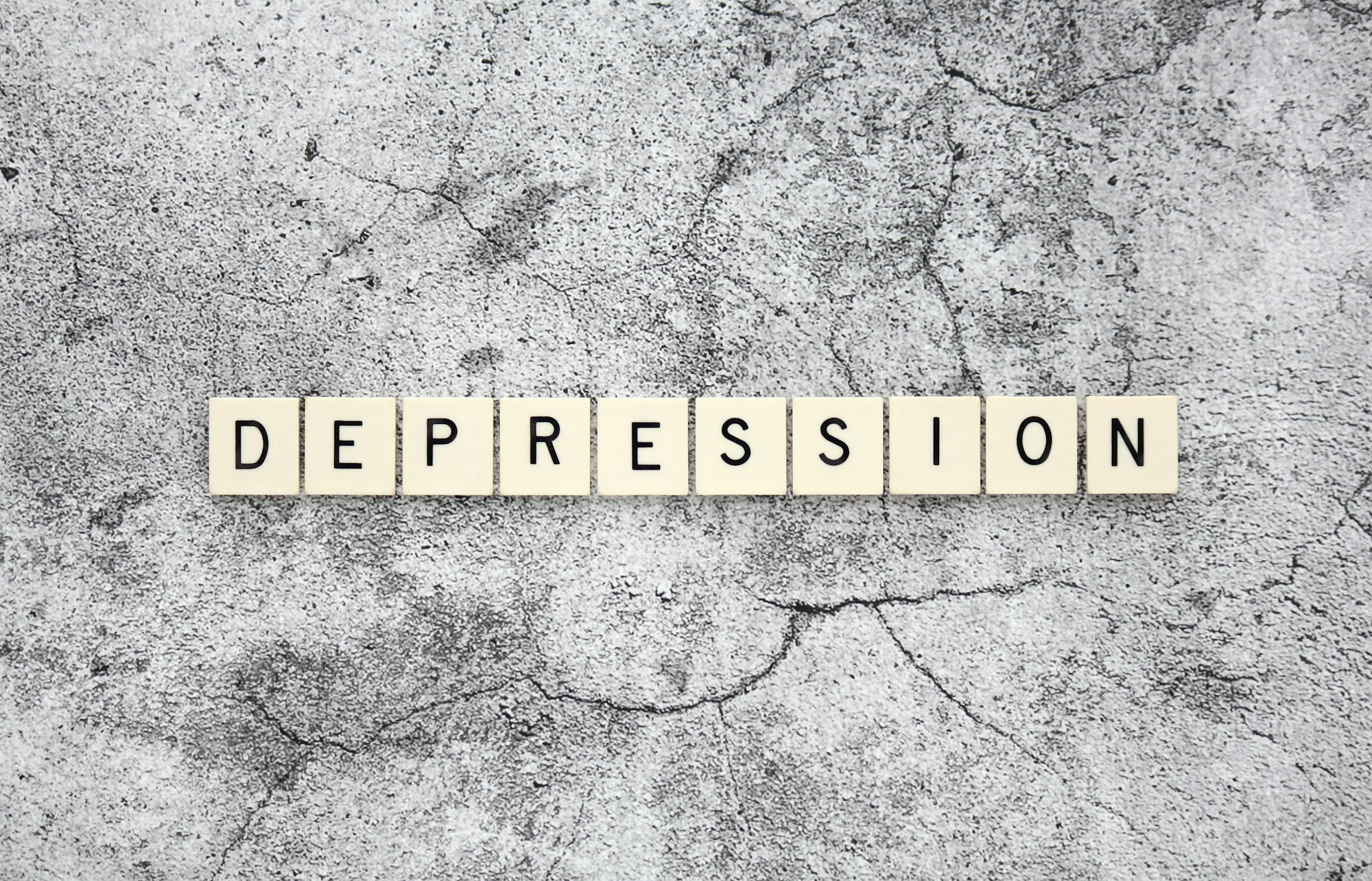 Depression word tiles on a cracked concrete background